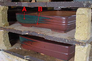 Mistakes in the manufacture of bonsai pots - color changes (A) in the glaze and a small crack (B)
